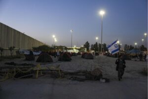 Israeli activists set up tents for blocking trucks carrying humanitarian aid into the Gaza Strip at the Kerem Shalom border crossing between Israel and Gaza, in southern Israel, Wednesday, Feb. 7, 2024. The activists say no aid should enter the territory until Israeli hostages held captive by the Hamas militant group are released.
