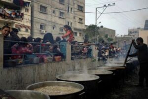 Palestinians line up for food in Rafah, Gaza Strip, in December.