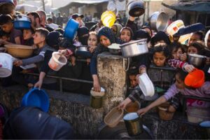 Palestinians line up for a free meal in Rafah