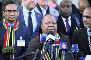 South Africa’s Minister of International Relations and Cooperation Naledi Pandor (C) speaks to press members following the International Court of Justice (ICJ) ruling for Gaza in Lahey, Netherlands on January 26, 2024.