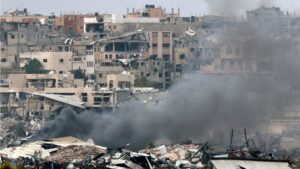 A picture taken from southern Israel near the border with the Gaza Strip on 21 December 2023, shows smoke billowing amid the destruction in northern Gaza