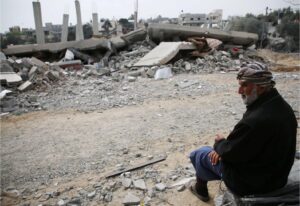 A Palestinian elder sits amid the rubble after an overnight airstrike in Khan Younis, March 29, 2024