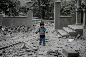 A Palestinian child walks amid the rubble of a house destroyed by Israeli bombardment in Gaza City on Sunday