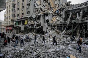 Palestinians walk amid the rubble of houses destroyed by Israeli bombardment in Gaza City on Sunday