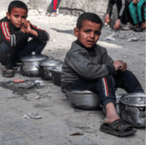 Boys sit with empty pots in Rafah on Saturday as displaced Palestinians line up for meals provided by a charity organization ahead of the fast-breaking iftar meal during the Muslim holy month of Ramadan