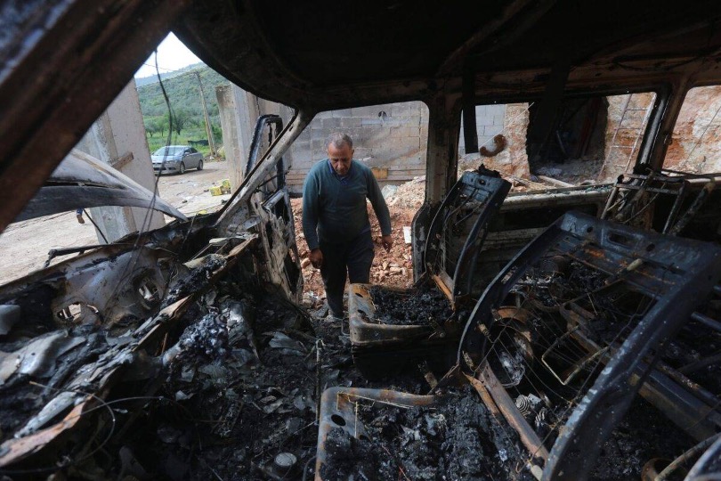 Palestinian residents inspect the destroyed house and vehicles set on fire by Jewish settlers who infiltrated the village overnight, in Nablus, West Bank on 11 April, 2024