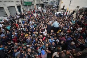 Palestinians wait in long queues for hours in order to buy bread in Gaza City