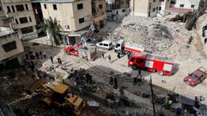 Palestinians gather to inspect the damage after an Israeli raid at Nur Shams camp, in Tulkarm, in the occupied West Bank, 21 April 2024