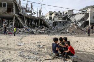 Palestinian children near the rubble of heavily damaged buildings after Israeli attacks on houses in Rafah, Gaza, on April 25, 2024