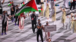 Flag bearers Dania Nour and Mohammed Hamada lead their team during the Opening Ceremony of the Tokyo 2020 Olympic Games