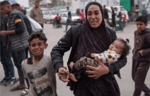 A Palestinian family arrives at a hospital where casualties of Israeli bombardment on al-Bureij camp in the central Gaza Strip were transported on Monday.