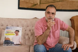 Ahmed Hamed, with a picture of 17-year-old son Omar, killed by Israeli settlers.