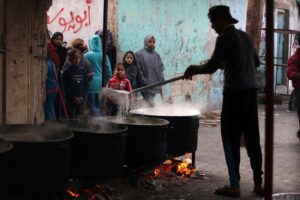 Volunteers prepare a meal for Palestinians in Rafah, southern Gaza, on 23 December 2023.