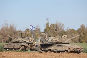 Israeli soldiers on their tanks near the border fence with the Gaza Strip, March 10, 2024.