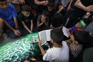 Palestinian students surround the body of their school teacher, Allam Jaradat, during his funeral at a mosque in Silat al-Harithiya, east of Jenin in the occupied West Bank, following the Israeli raid