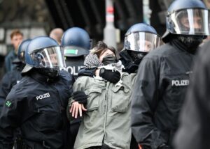 A pro-Palestinian protester at the department of social sciences at Berlin’s Humboldt University is removed from the building by police.