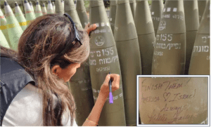 Former U.S. presidential candidate Nikki Haley signs artillery shells near the northern border of Israel on Tuesday, May 28, 2024.