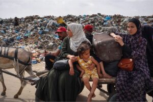 Palestinian women and children flee Rafah with their belongings following renewed Israeli strikes in the city in the southern Gaza Strip on May 28, 2024