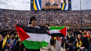 Students protest in support of Palestine during the University of Michigan's Spring Commencement ceremony on May 4, 2024 at Michigan Stadium in Ann Arbor, Michigan