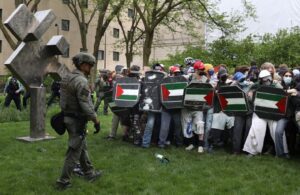 Pro-Palestine protesters stand firm as Chicago police officers prepare to begin arrests at the Art Institute of Chicago in Chicago, Illinois on May 4, 2024. Protests on US school campuses are continuing nationwide, with pro-Palestine encampments calling on institutions to divest investments in Israel and in support of a ceasefire in Gaza