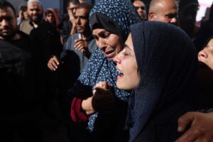 The widow of slain journalist Hamza al-Dahdouh at her husband's funeral