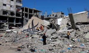 Children standing amid the rubble of a building in Rafah that was destroyed by Israeli airstrikes in February.