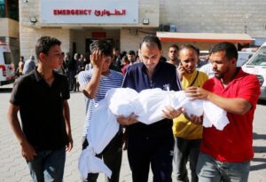 Relatives carry the body of 13-year-old Abdullkadir Al-Sarhi, who, due to malnutrition and lack of medical supplies, lost his life at Al-Aqsa Martyrs Hospital in Deir al-Balah, Saturday