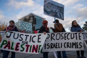 Protesters gather outside the ICC to call for the court to prosecute Israel for war crimes.