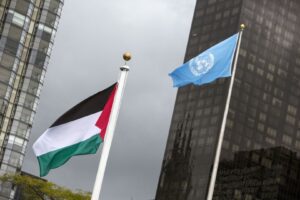 The Palestinian flag flies beside the flag of the UN after being raised by President Mahmoud Abbas, Oct. 1, 2015