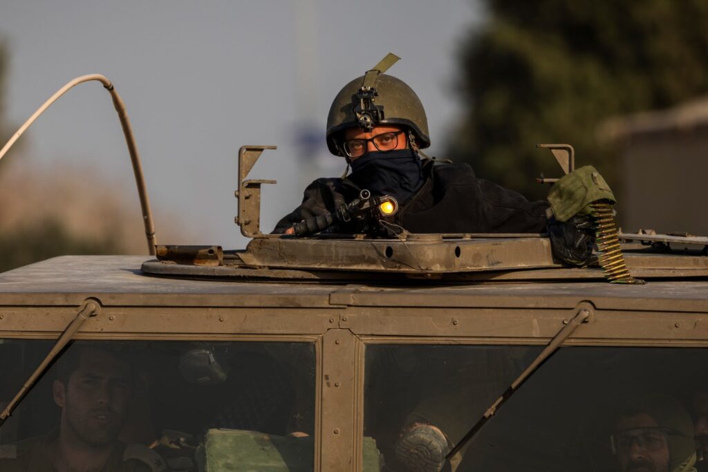 Israeli soldiers sit in a tank near the Israeli-Gaza border after the end of a seven-day truce between Israel and Hamas, December 1, 2023, Kibbutz Beeri