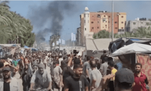 Crowds of Palestinians flee the area after an Israeli attack on the Mawasi area of Khan Younis.