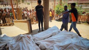 Bodies are laid out for identification and prayers after the latest attack on Mawasi in Gaza.