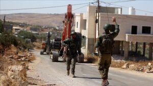 Heavy duty machines of Israeli forces demolish a Palestinian family's house allegedly for being unauthorized in Nablus, West Bank on July 30, 2024.