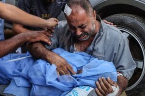 Relatives of Palestinians killed by the Israeli attack on Nuseirat refugee camp mourn as the bodies are brought to al-Aqsa Martyrs Hospital in Deir al-Balah, Gaza on August 10, 2024. (Photo by Ali Jadallah/Anadolu via Getty Images)