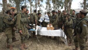 Israeli soldiers of the Netzah Yehuda Battalion hold morning prayers as they take part in their annual unit training in the Israeli-annexed Golan Heights, near the Syrian border, May 19, 2014. — MENAHEM KAHANA/AFP via Getty Images