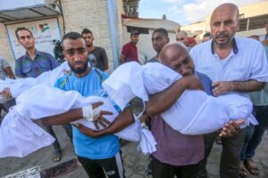 Relatives of Palestinian children, who lost their lives following the Israeli attack on Nuseirat refugee camp, mourn as the bodies are brought to al-Aqsa Martyrs Hospital in Deir al-Balah, Gaza on August 10, 2024. [Ashraf Amra – Anadolu Agency]