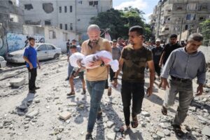 Relatives of Palestinian children, killed in an Israeli attack on the Nuseirat refugee camp, carry the bodies to Al-Aqsa Martyrs Hospital in Deir el-Balah, in central Gaza, on August 16 [Hassan Jedi/Anadolu Images]