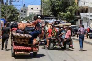 Palestinians, carrying their belongings, are on their way to safer areas following the Israeli army’s warning for the evacuation of Abu Areef and al-Mazra areas in Deir el-Balah [Abed Rahim Khatib/Anadolu Agency]