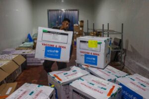 A worker unloads a shipment of polio vaccines provided with support from UNICEF to the Gaza Strip through the Karm Abu Salem crossing, also known as Kerem Shalom, at a depot belonging to Gaza’s health ministry on August 25, 2024 [EYAD BABA/AFP via Getty Images]