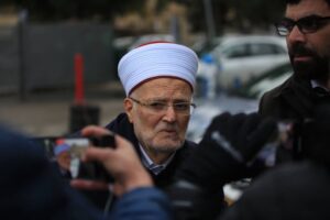 Sheikh Ekrima Sa’id Sabri, the former grand mufti of Jerusalem and the Palestinian territories walks outside an Israeli police station after being summoned for interrogation, in Jerusalem on January 2, 2023. [Saeed Qaq/NurPhoto via Getty Images]