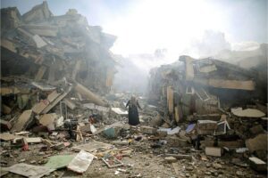 A woman in Gaza walks through the rubble of residential buildings after Israeli airstrikes on the al-Zahra neighborhood in the Gaza Strip in late October.Credit: MUSTAFA HASSONA / ANADOLU / Anadolu via AFP