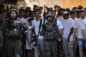 A group of Jewish settlers under the protection of Israeli soldiers raids the Old City area of Hebron, West Bank on September 14, 2024 [Mamoun Wazwaz/Anadolu Agency]