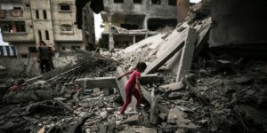 A Palestinian girl walks over rubble in the aftermath of Israel’s raid on Nuseirat refugee camp in Gaza on June 9, 2024. Photo: Majdi Fathi/NurPhoto via Getty Images