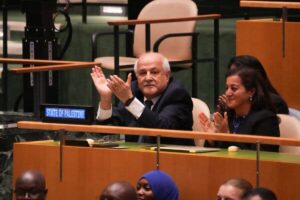 Riyad Mansour, left, the Palestinian ambassador to the United Nations, applauding the result of a vote during an emergency session at the U.N. General Assembly on Wednesday.Credit...Bryan Smith/Agence France-Presse — Getty Images