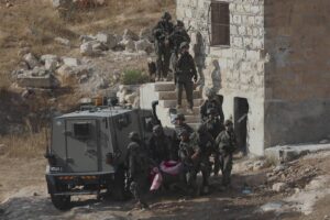 Israeli forces carry the dead body of a Palestinian after an operation in Hebron, West Bank on September 1, 2024. [Mamoun Wazwaz – Anadolu Agency]