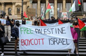 Protestors in Melbourne, Australia, hold a banner promoting the boycott of Israel at rally on October 10. The nearly 20-year-old movement to boycott, divest from, and sanction Israel, called BDS for short, has re-emerged this month after an attack violence by Hamas spurred retaliatory strikes by Israel. Asanka Ratnayake/Getty Images