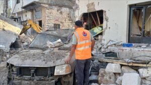 Emergency workers look through the remains of buildings after an Israeli attack on the Nabatiyeh Al Faouqa area close to Lebanon's border