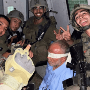 60-year-old Mahmoud Asafra from Beit Kahil near Hebron, surrounded by Israeli forces as they mock him.