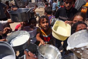 Displaced Palestinian children wait at a food distribution point in Deir el-Balah in the central Gaza Strip on Thursday.Eyad Baba / AFP - Getty Images