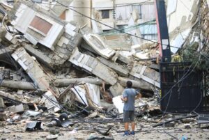 A man looks at the destruction at the site of an overnight Israeli airstrike in the Ruwais neighborhood in Beirut, on Oct. 1.